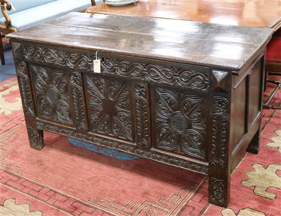 An 18th century carved oak coffer, W.138cm